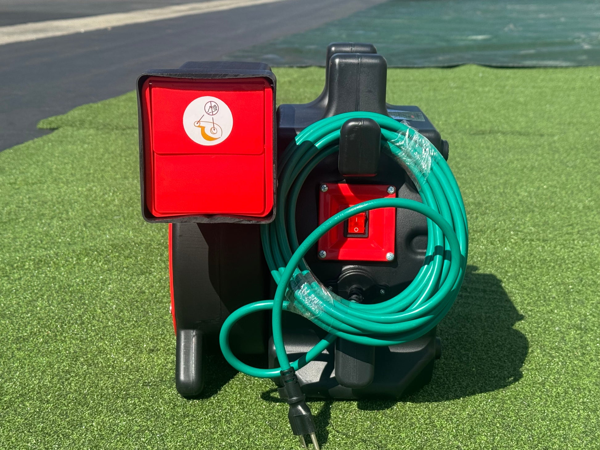 Rear of the bounce house blower showing the power switch and cord wrap