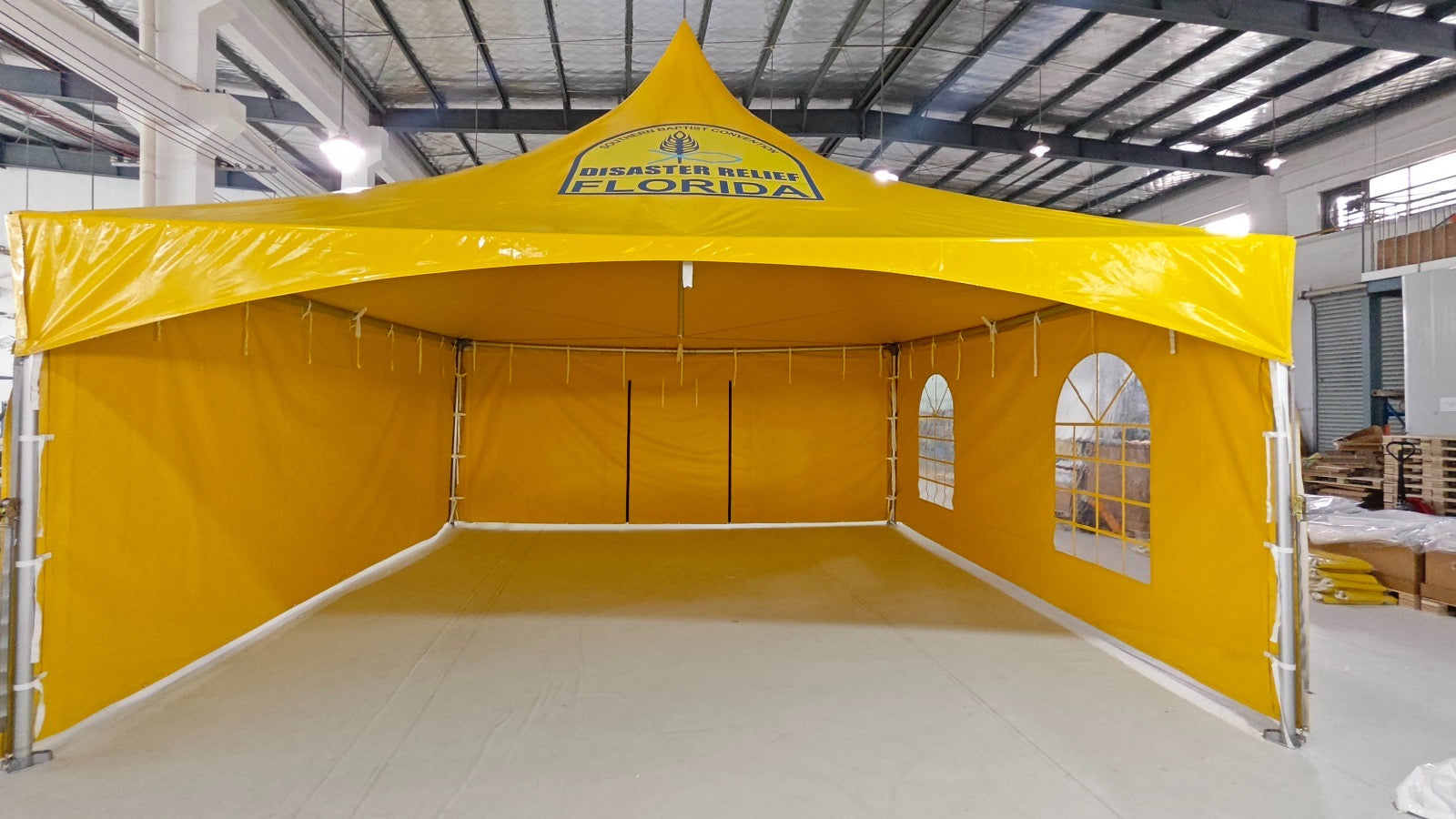 Interior of a custom printed high peak frame tent with sidewalls fitted